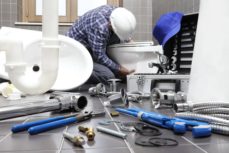 a man working on a toilet